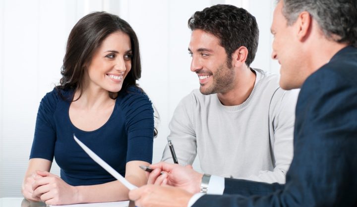A young couple discussing with a UK partner visa consultant
