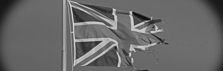 A torn British flag flying in the wind